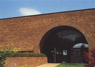 A brick building with a tree in front of it.